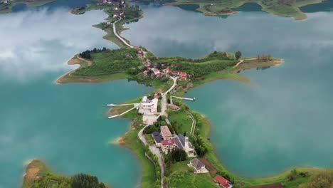 fly over drone shot above the šćit franciscan monastery at rama lake