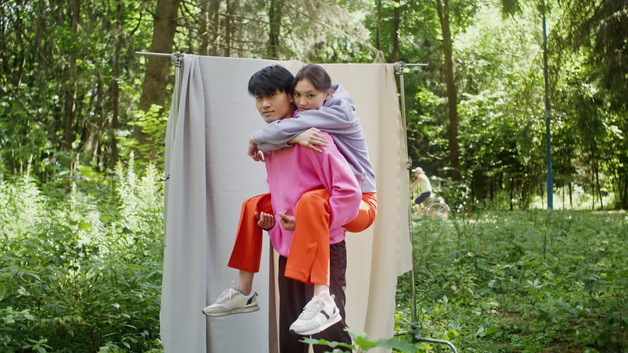 Couple Enjoying Piggyback Ride in Nature