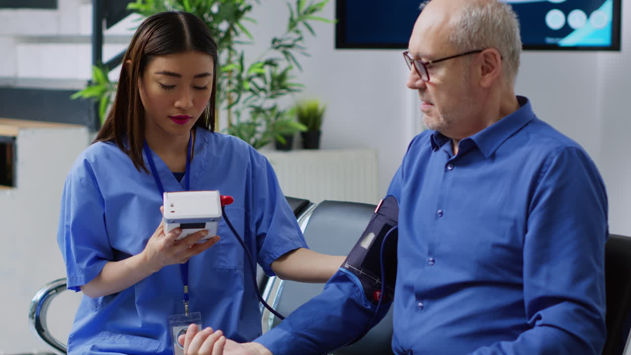 Nurse checking blood pressure of patient
