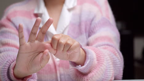 close-up of woman self-massage and relaxation arthritis with stretching finger and arm after her hand painful of office syndrome