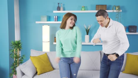 Father-dancing-with-his-young-adult-daughter-at-home.-They-are-happy.