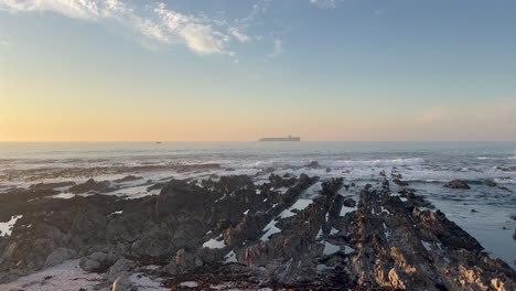 sunset over a rocky outcrop along the sea point coastline