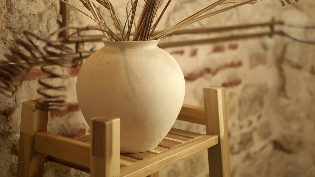 Vase with Dried Flowers on Wooden Shelf