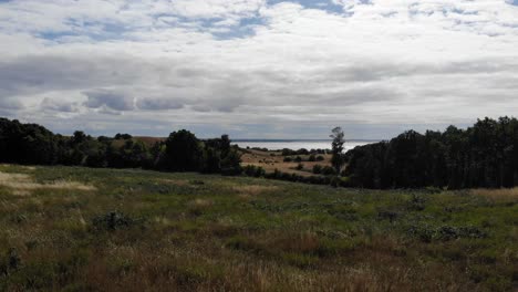 Vista-Aérea-De-La-Costa-De-SejerÃ¸bugten-Con-Colinas,-Campos-Y-Océano.