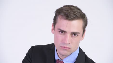 face of young handsome businessman in suit wearing sunglasses