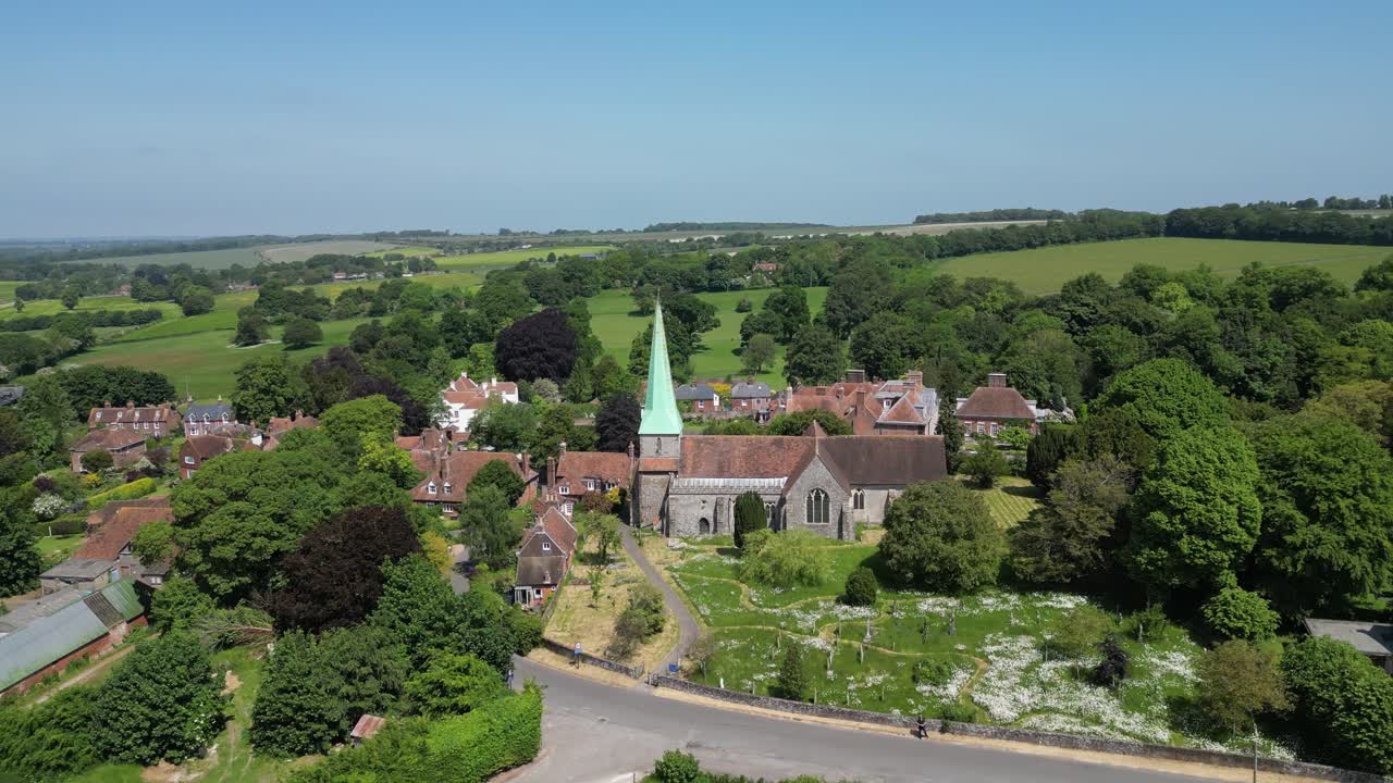 Drone shot flying backwards to show the village church in Barham in Kent, UK