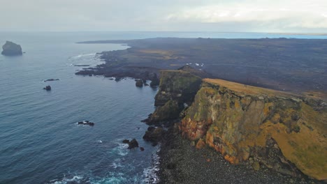 Aerial-Drone-View-Of-Valahnukamol-Cliffs-Iceland-With-Long-Rocky-Ocean-Coastline-During-Dim-Moody-Foggy-Weather