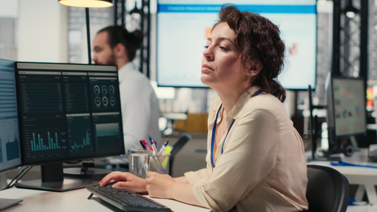 Vertical Video Female employee in a high end office analyzing performance metrics