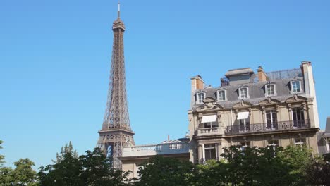 eiffel tower with architectural building haussmann style and blue sky in paris, france - 4k