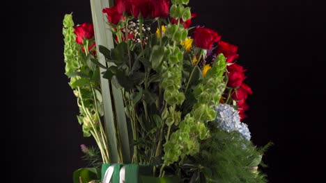 Flowers-arrangement-bouquet-with-roses-sunflowers-gerberas-daisy-spinning-in-black-background