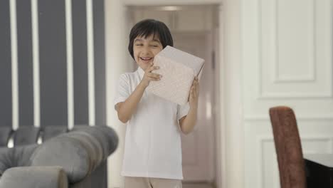 happy indian boy receiving a gift