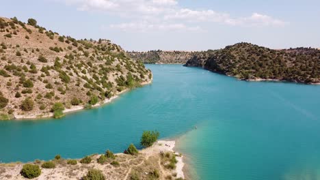 embalse del arquillo de san blas, teruel, aragon, spain - aerial drone view of the dam lake and turquoise water reservoir