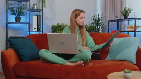 Young-businesswoman-working-with-laptop-computer-and-documents,-planning-expenses-budget-at-home