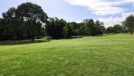 pan across a tranquil, sunny golf course