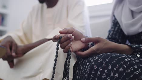 african muslim couple at home in ramadan reading quran holly islam book