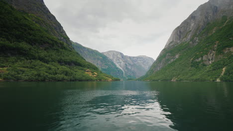 fly low over the surface of the water in the picturesque fjord of norway the beautiful nature of sca