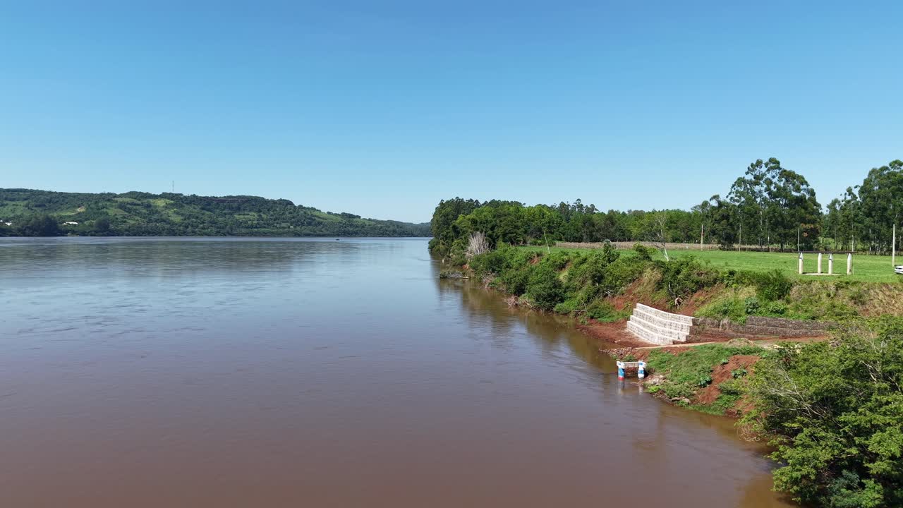 Scenic aerial panorama of rural riverside landscape with forest and countryside houses, Rio Grande do Sul Brazil tourism