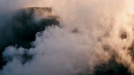 steam rising from industrial facility