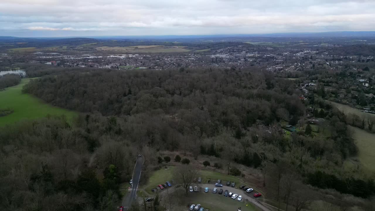 Aerial view of Reigate Hill, England with vast woodland and townscape in the background