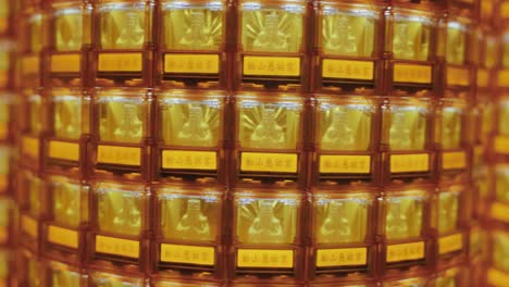 close-up of many golden buddha statues glowing in illuminated niches at ciyou temple in taiwan, symbolizing devotion, peace, and spiritual reverence in a sacred buddhist space