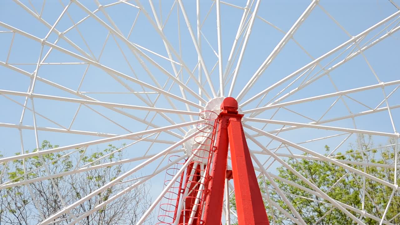 Brightly colored Ferris wheel against the blue sky