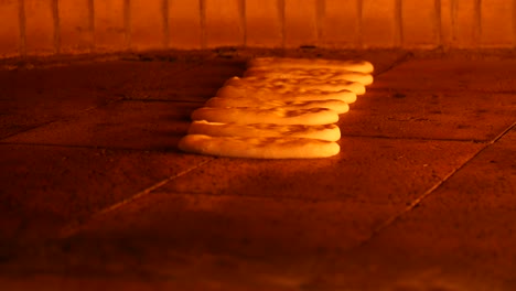 pide bread baking in a wood-fired oven