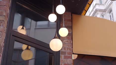 modern pendant lights on brick building exterior