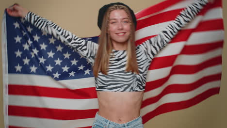 lovely young woman waving and wrapping in american usa flag, celebrating, human rights and freedoms