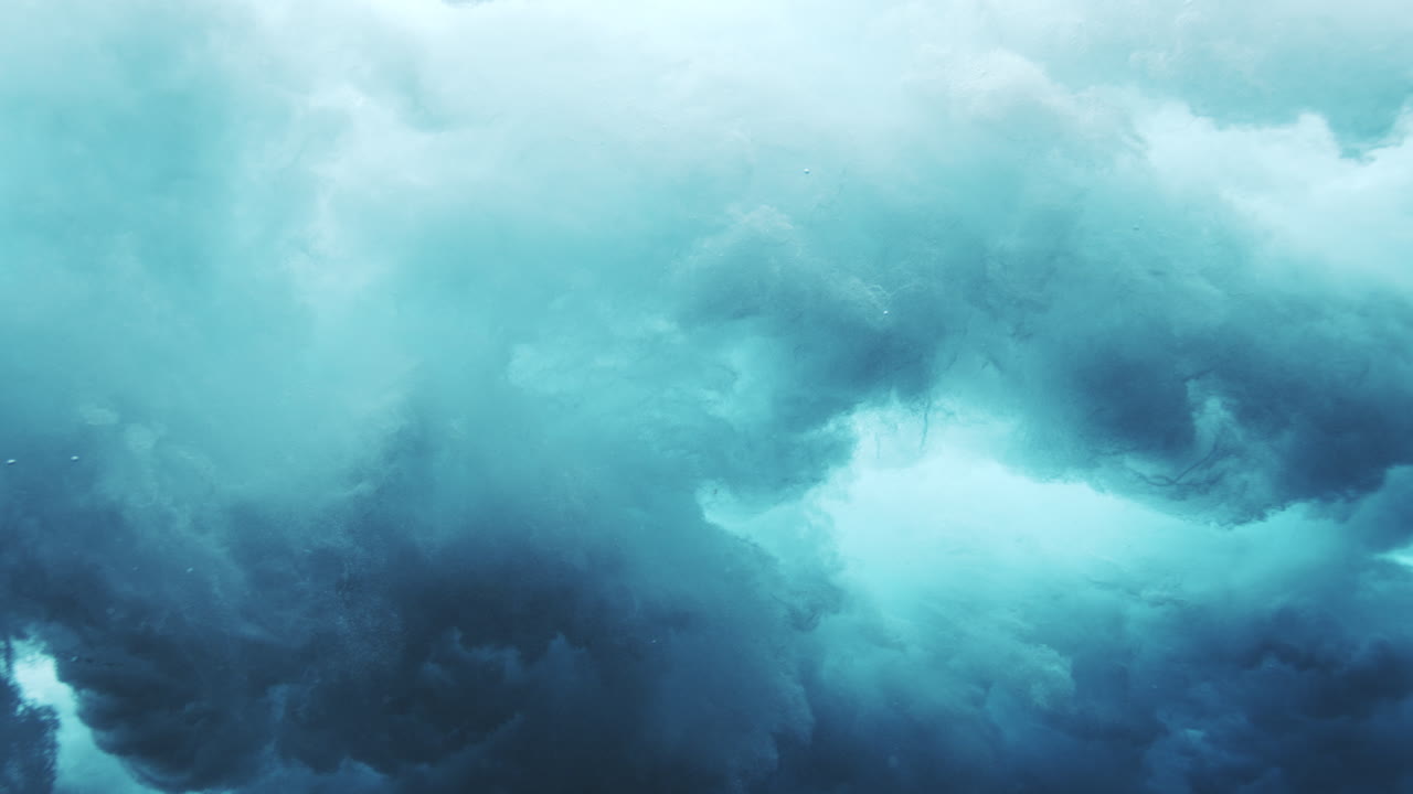 Turbulent underwater wave cloud with swirling foam and deep ocean blue tones