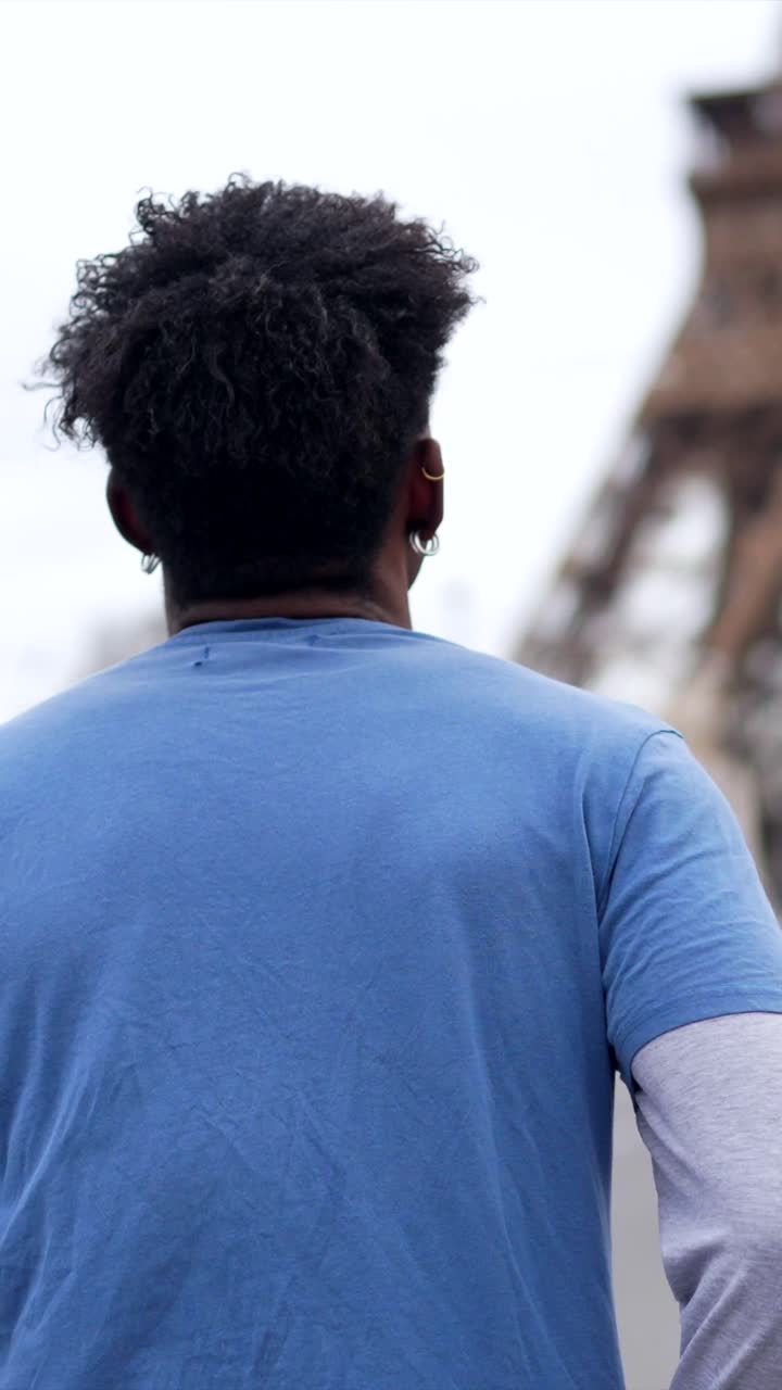 Man running in front of Eiffel Tower