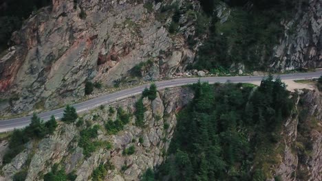 drone shot of a mountain road next to a cliff
