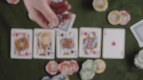 a person flip up with his hands one "100" value token into the air