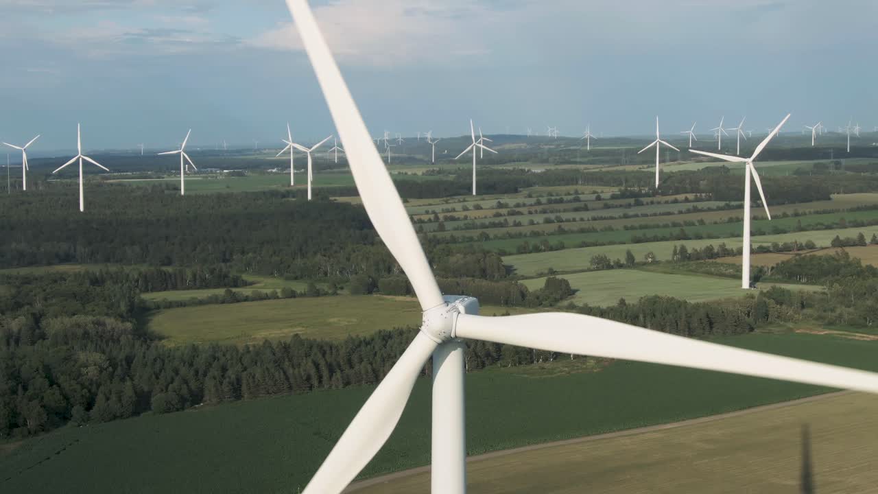 Wind Farm In Northern Quebec - Propellers Of A Wind Turbine Spinning On A Sunny Day Near The Saint Lawrence River In Canada. - close up aerial