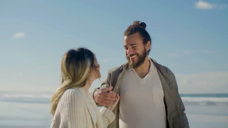 Romantic-Caucasian-couple-strolling-along-seashore