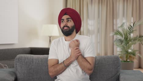 sick sikh indian man suffering from hand pain