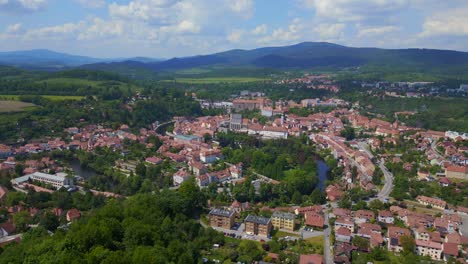 Dramatic-aerial-top-view-flight-mountain-overview-Hill-town-Panorama,-Krumlov-Czech-Republic-Summer-2023