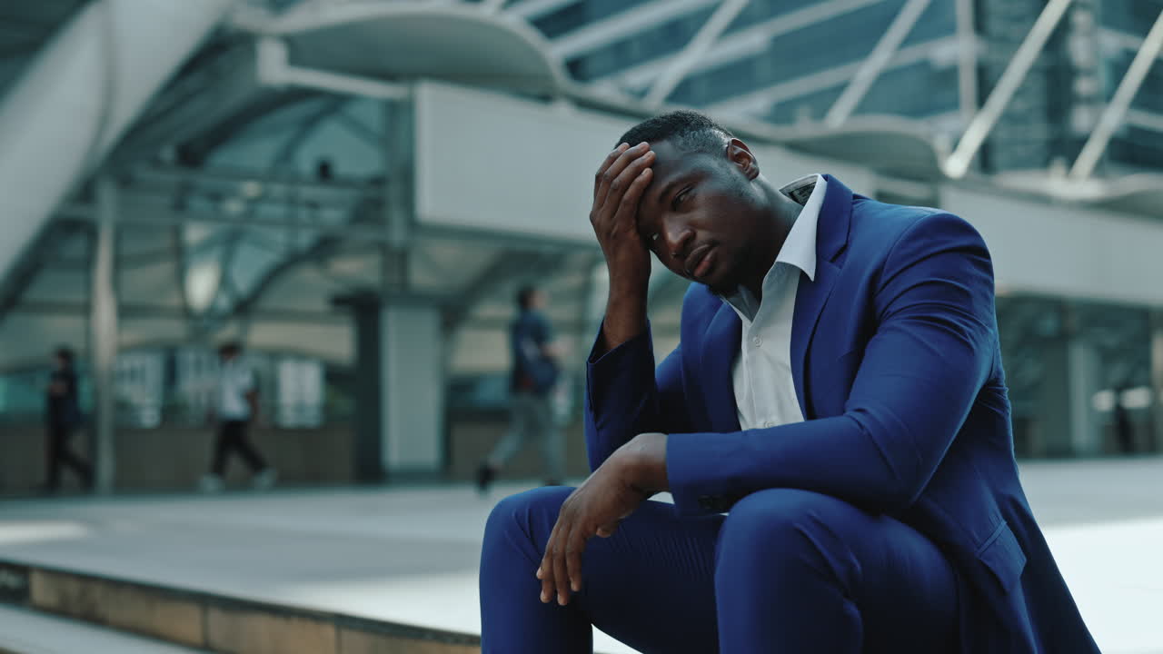 Stressed Businessman Sitting Outdoors in a City