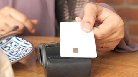 woman paying with credit card at restaurant