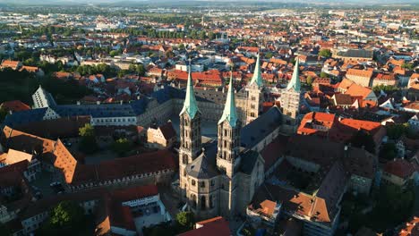 drone flying back revealing church and cityscape in bamberg