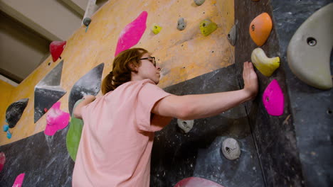 boy bouldering in a gym