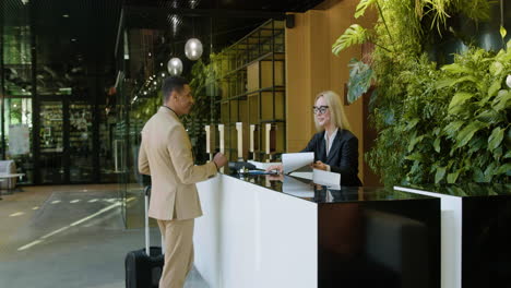 blonde receptionist at the entrance of a hotel