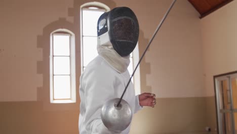 Female-fencer-athlete-during-a-fencing-training-in-a-gym