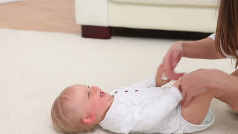 baby laughing when woman playing with him