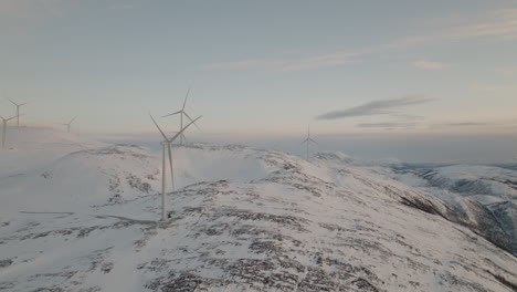 Spinning-Wind-turbines-on-top-of-snowy-island-in-Norway