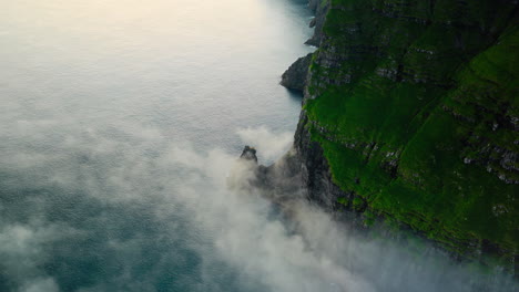 Dramatic Green Cliffs and Ocean with Mist