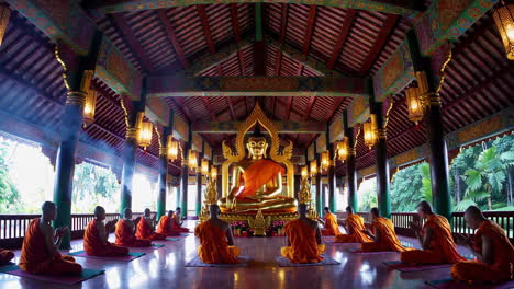 buddhist monks in prayer at a temple