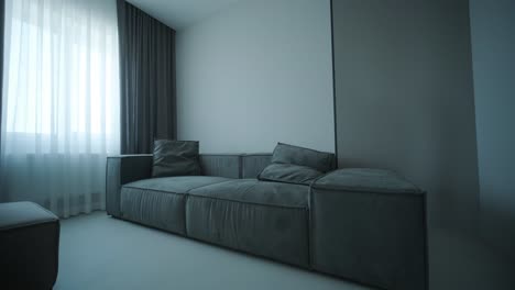 modern living room with dark gray sofa and curtains