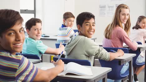 Animation-of-schoolchildren-sitting-at-desks-in-classroom,-turning-and-smiling-to-camera