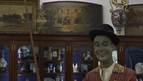 Close-up-tilt-down-shot-of-old-snooker-player-statue-in-antique-store