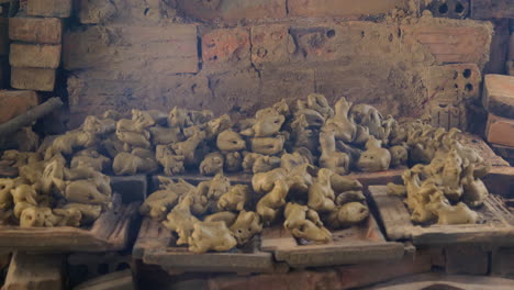 Close-up-of-smoke-and-clay-figurines-atop-traditional-Vietnamese-kiln,-Than-Ha-Hoi-An